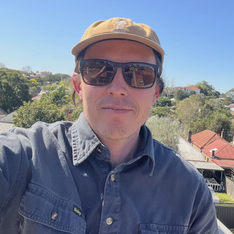 Tillman Kiesow wearing a cap and sunglasses on a rooftop